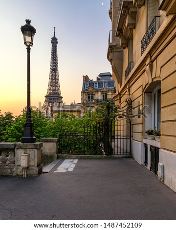 Cozy street with view of Paris Eiffel Tower in Paris, France. Eiffel Tower is one of the most iconic landmarks in Paris. Architecture and landmark of Paris. Eiffel tower in summer, France.