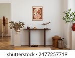 Cozy and stylish interior of living room with mock up poster frame, wooden console, flowers in vase, decorations and personal accessories. Modern home decor. Template.