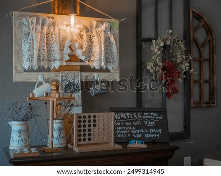 A cozy table setup with a warm lamp and an inviting sign, creating a welcoming atmosphere perfect for relaxation or reading. The soft lighting and charming decor add to the overall comfort.