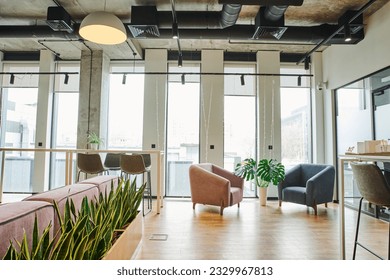 cozy waiting lounge with large windows, soft and comfortable armchairs, green and natural plants in modern coworking environment, workspace organization concept