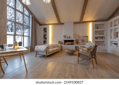 Cozy Warm Home Interior Of A Chic Country Chalet With A Huge Panoramic Window Overlooking The Winter Forest. Open Plan, Wood Decoration, Warm Colors And A Family Hearth.