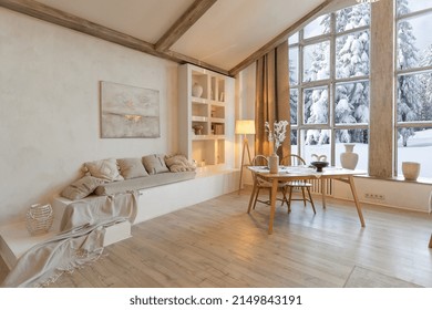 Cozy Warm Home Interior Of A Chic Country Chalet With A Huge Panoramic Window Overlooking The Winter Forest. Open Plan, Wood Decoration, Warm Colors And A Family Hearth