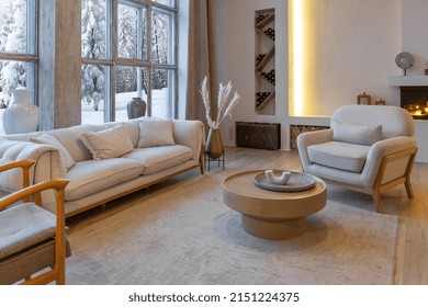 Cozy Warm Home Interior Of A Chic Country Chalet With A Huge Panoramic Window Overlooking The Winter Forest. Open Plan, Wood Decoration, Warm Colors And A Family Hearth