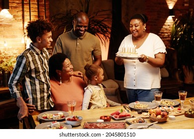 Cozy Warm Toned Portrait Of Happy African-American Family Celebrating Birthday Together Indoors At Evening