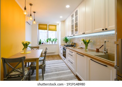 cozy well designed modern kitchen interior with appliances and dining table