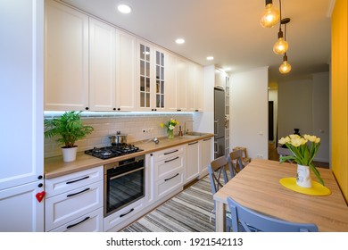 cozy well designed modern kitchen interior with appliances and dining table