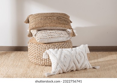 A cozy white background features a decorative pillow, a basket, and a warm blanket with colorful tassels - Powered by Shutterstock