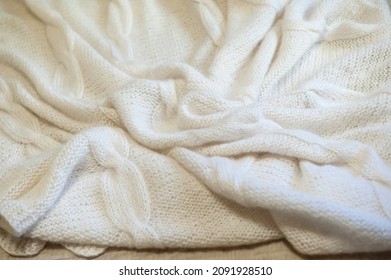 Cozy White Knit Mohair Blanket On A Bed 