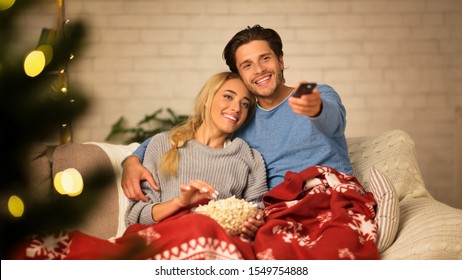 Cozy Winter Evening. Loving Couple Watching Tv And Eating Popcorn At Home