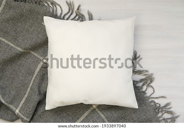 Cozy\
winter flat lay composition with white blank pillow and warm wool\
blanket, square pillow case, cushion mockup.     \
