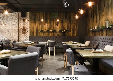 Cozy wooden interior of restaurant, copy space. Comfortable modern dining place, contemporary design background - Shutterstock ID 717595390