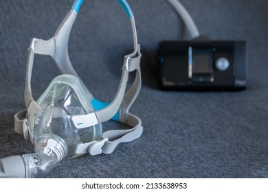CPAP mask with a full face mask cpap machine against obstructive sleep apnea helps patients as respirator mask and headgear clip for breathing medication in snoring sleep disorder to breath easier