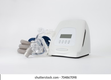 Cpap system includes of cpap machine,mask,tube and headgear,front view studio shot.Full components of Cpap machine ,isolated white background.