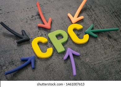 CPC, cost per click the main KPI for online advertising industry, colorful arrows pointing to the word COST at the center on chalkboard wall.