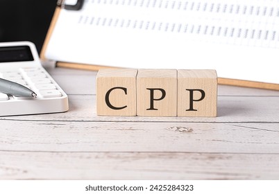 CPP word on wooden block with clipboard and calculator