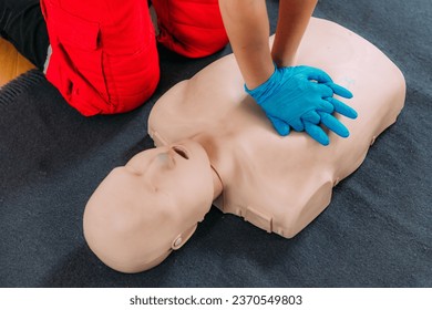 CPR Training Course. Chest compression techniques in a CPR first aid training with a dummy.
