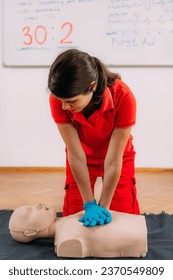 CPR Training Course. Chest compression techniques in a CPR first aid training with a dummy.