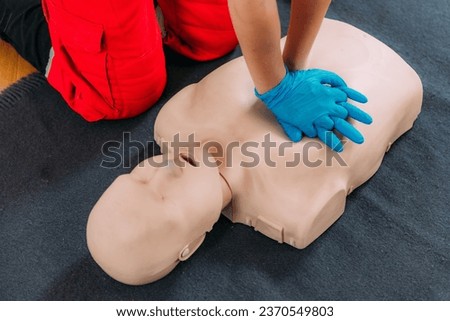  CPR Training Course. Chest compression techniques in a CPR first aid training with a dummy.