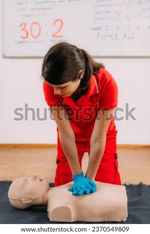 CPR Training Course. Chest compression techniques in a CPR first aid training with a dummy.