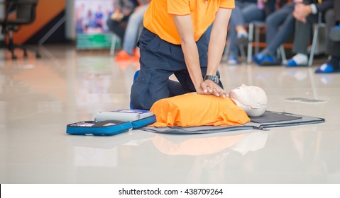 CPR Training Demonstrating  Chest Compression On A Dummy 