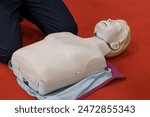 CPR Training Manikin on Red Mat