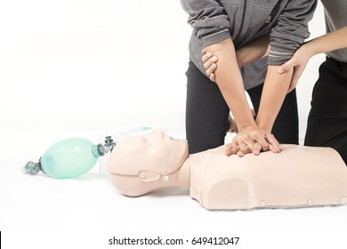 CPR Training Medical Procedure,Demonstrating Chest Compressions On CPR Doll In The Class,White Background