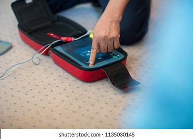 CPR training using and an AED and bag mask valve on an adult training manikin.  First aid cardiopulmonary resuscitation course using automated external defibrillator device, AED. - Powered by Shutterstock