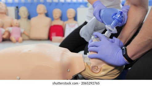 CPR training using and an AED and bag mask valve on an adult training manikin. - Powered by Shutterstock