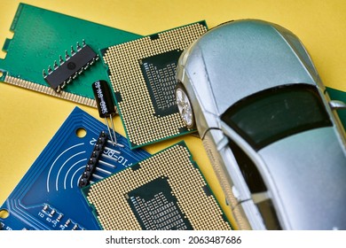 CPU chip and semiconductors with car toy. Global car chip shortage. Micro-chip shortage creates dearth of new cars. Computer chip shortage stalls car industry production - Shutterstock ID 2063487686