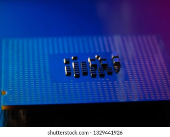 CPU processor pins up in blue and red light close-up