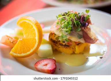 Crab Cake Benedict On A White Plate At A Cuban Fusion Restaurant