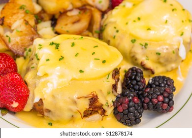 Crab Cake Eggs Benedict Served With Berries And German Potatoes