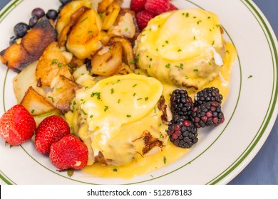 Crab Cake Eggs Benedict Served With Berries And German Potatoes