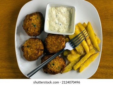 Crab Cakes With Tarter Sauce  And A Side Of Fries