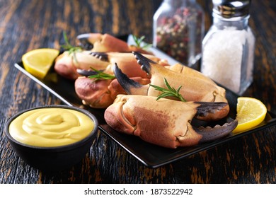 crab claws with  mustard sauce , lemon and rosemary  in a restaurant, close-up.