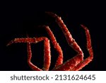 crab phalanx, sea delicacy on a dark background. large red Kamchatka crab claws phalanx legs tentacles
