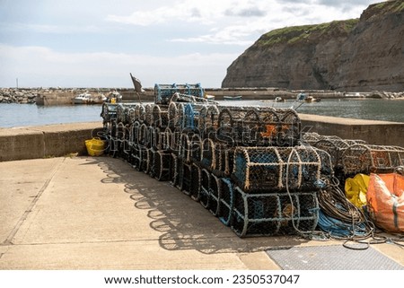 Crab pots lobster pots and fish traps on the quayside in the fishing village of Staithes on the North Yorkshire coast