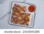 crab rangoon on a white marble background