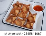 crab rangoon on a white marble background