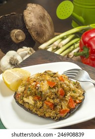 Crab Stuffed Portobello Mushroom Set On Serving Plate With Fresh Ingredients Behind