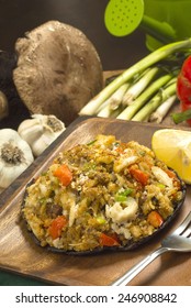 Crab Stuffed Portobello Mushroom Set On Serving Plate With Fresh Ingredients Behind