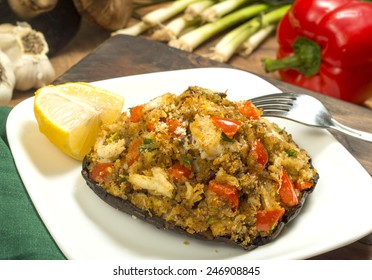 Crab Stuffed Portobello Mushroom Set On Serving Plate With Fresh Ingredients Behind