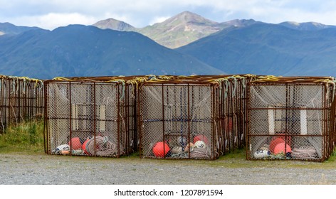 Crab Traps and Buoys Stacked on a Dock in Dutch Harbor Unalaska with Mountains in the Background
