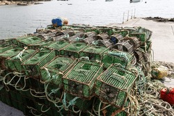 Crab Traps Stacked On A Harbor Of Galicia Coast, Spain. Pile Of Lobster Pots On Outdoors And Atlantic Ocean At Background