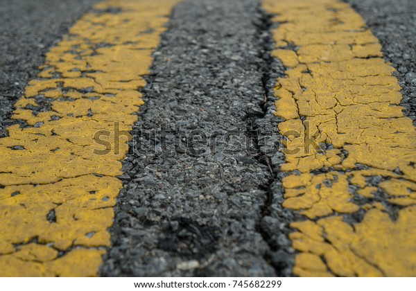 crack asphalt road  yellow
line