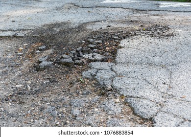 crack in asphalt street -broken asphalt