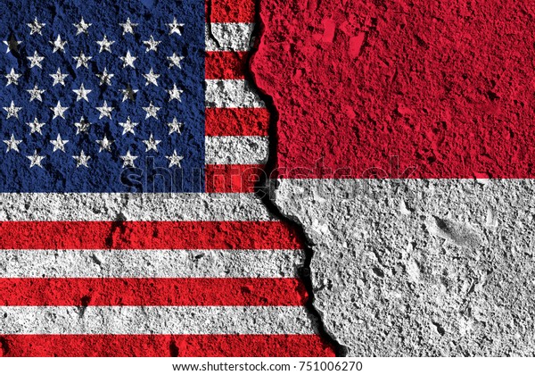 Crack between America and Indonesia flags.\
political relationship\
concept
