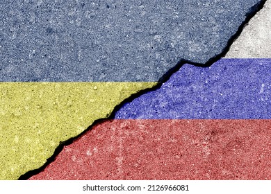 The crack between the Russian Federation and Ukrainian flags on the concrete wall. The concept of sanctions, war, the deterioration of diplomatic relations, confrontation and severance of agreements. - Shutterstock ID 2126966081