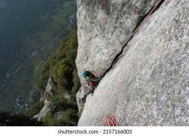 Crack climbing in the most famous trad route in the central alps named Luna Nascente, in Mello Valley