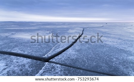  crack in the ice a cloudy sunset / winter landscape cloudy gloomy